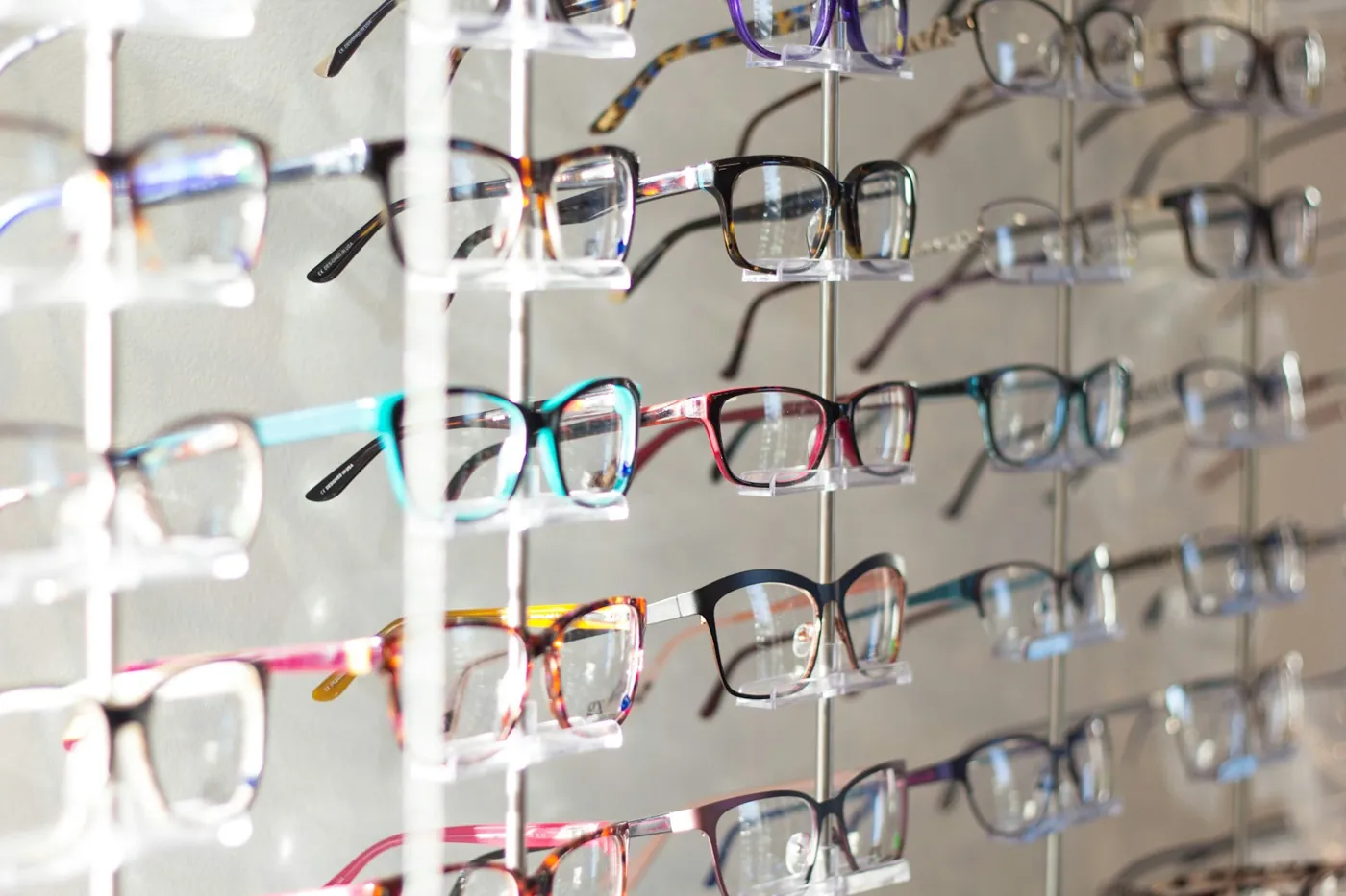 Wall of colorful designer eyeglass frames on display